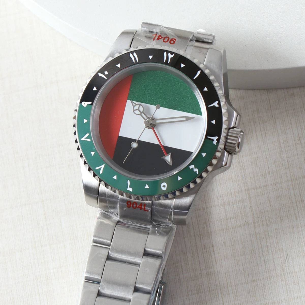 NH34 GMT watch with a UAE flag dial and Arabic numerals on the bezel. Stainless steel case and bracelet with automatic mechanical movement.